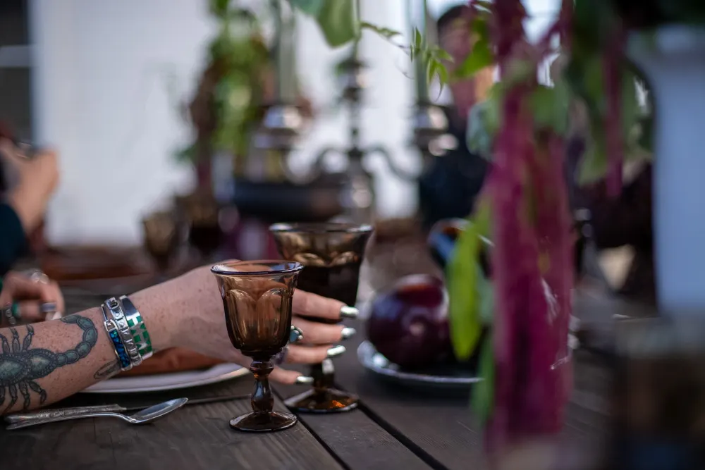 A hand lifting an amber goblet.